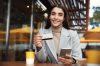 Online payment and shopping concept. Businesswoman sitting in cafe with credit card and mobile phone, purchase something in internet or transfer money Online payment and shopping concept. Businesswoman sitting in cafe with credit card and mobile phone, purchase something in internet or transfer money.
